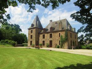 a large stone building with two towers on a grass field at Luxurious Castle with Private Pool and Sauna in Basse-Bodeux