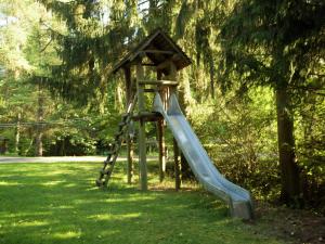 a playground with a slide in a park at Feriendorf Reinskopf in der Eifel in Schönecken