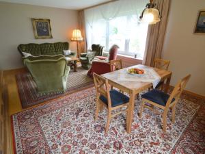 a living room with a table and chairs at Holiday home in Densborn with garden in Zendscheid