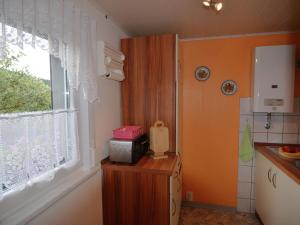 a kitchen with a window and a microwave on a counter at Holiday home in Thuringia in Neuhaus am Rennweg