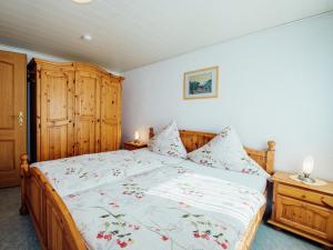 a bedroom with a large bed with a wooden headboard at Apartment near the forest in Plankenstein in Plankenfels