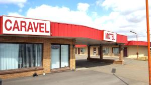 a caravale store with a sign on top of it at Caravel Motel in Swift Current