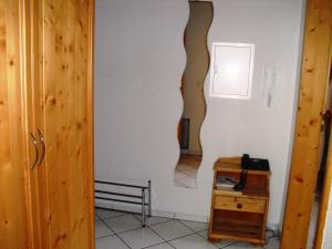 a hallway with a wall with a mirror and a table at Farmhouse Escape in Hofstetten in Hofstetten
