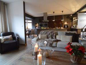 a living room with a couch and a table with candles at Beautiful Apartment in Spa near Casino in Spa