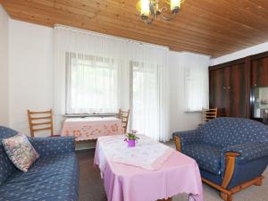 a living room with two chairs and a table at Comfortable apartment in Baiersbronn with balcony in Buhlbach