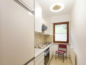a small kitchen with a counter and a chair in it at Comfortable apartment in Baiersbronn with balcony in Buhlbach