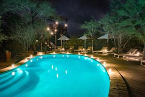 a swimming pool at night with lights at Unembeza Boutique Lodge & Spa in Hoedspruit