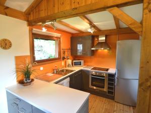 a kitchen with a stainless steel refrigerator and a sink at Pretty cottage Ardennes near the Valley of Lesse in Vencimont