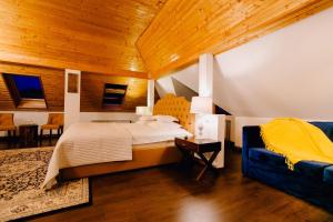 a bedroom with a large bed and a wooden ceiling at Casa Natalia in Sinaia
