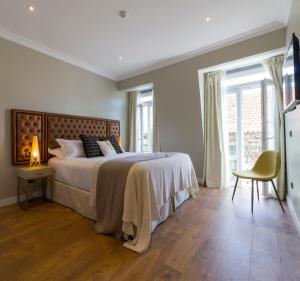 מיטה או מיטות בחדר ב-Bairro Alto Suites