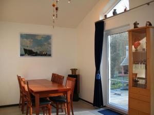 uma sala de jantar com uma mesa e cadeiras e uma janela em Tidy holiday home with dishwasher, in a green area em Kopp