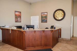 an office with a desk with a clock on the wall at National 9 Inn Price in Price