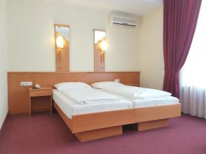 Postel nebo postele na pokoji v ubytování Hotel Haydn
