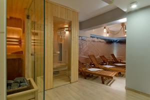 a room with a wooden floor and a walk in shower at B&B Molo in Sopot
