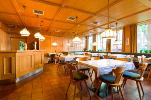 a restaurant with tables and chairs and lights at Kolpinghaus Bolzano in Bolzano