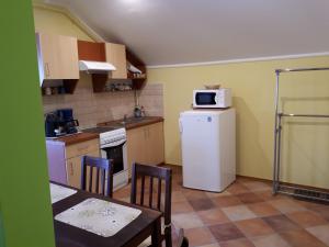 A kitchen or kitchenette at Rozmaring Apartmanok