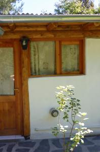 a house with a wooden door and windows at Valle de Epuyen in Epuyén