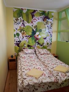 A bed or beds in a room at Rozmaring Apartmanok