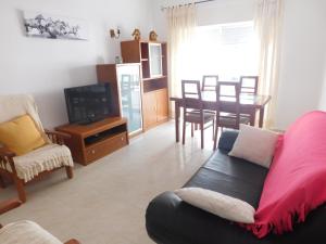 a living room with a couch and a tv and a table at Casa Happybella in Lagos