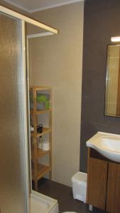 a bathroom with a sink and a toilet and a mirror at Apartamentos Pátio da Aldeia in Armação de Pêra +70 photos