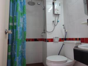 a bathroom with a shower and a toilet and a sink at Sakol Hotel in Nakhon Ratchasima +34 photos