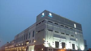 a building with a blue sign on the top of it at Temasek Hotel in Melaka