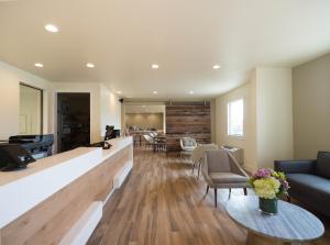 a living room with a couch and a table at Hotel Focus SFO in South San Francisco