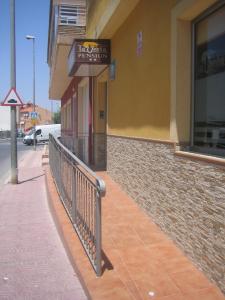 a street sign on the side of a building at Pensión La Venta in Puerto de Mazarrón