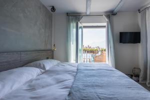 a bedroom with a large bed with a large window at Seven Boutique Hotel in Ascona