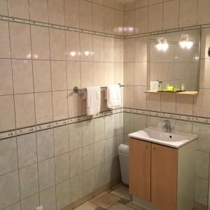 a bathroom with a sink and a toilet at Aux Vieux Arceaux in Mercuer