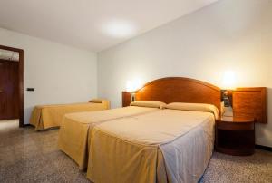 Postel nebo postele na pokoji v ubytování Hotel Gaudi