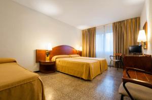 Postel nebo postele na pokoji v ubytování Hotel Gaudi