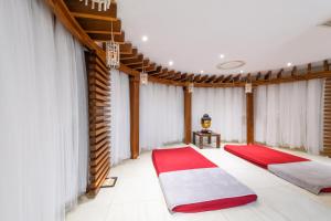 two beds in a room with a red and white carpet at Asterias Beach Hotel in Ayia Napa