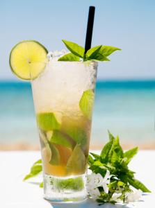 a drink with a lime and a straw in a glass at Asterias Beach Hotel in Ayia Napa