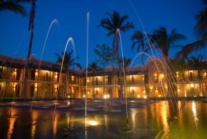 a building with a fountain in front of it at night at Avani Pemba Beach Hotel in Pemba