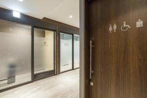 a hallway with glass doors in a building at Hotel M's Est Shijo Karasuma in Kyoto