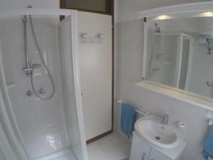 a bathroom with a shower and a toilet and a sink at Condominio Sole - Agenzia Cocal in Caorle