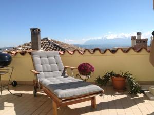 a chair on a patio with a view of a roof at BellaVista Bike Stop in Spoltore