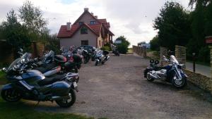 un grupo de motocicletas estacionadas frente a una casa en Willa Dzika Róża en Sandomierz