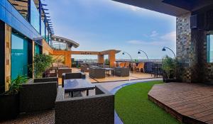 an outdoor patio with tables and chairs on a building at Renest Jaipur in Jaipur