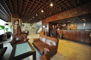 a lobby with leather couches and a reception desk at Hotel Melnik Хотел Мелник in Melnik