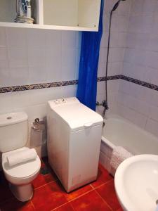 a bathroom with a toilet and a sink and a tub at Hola Apartments 14-3 in Playa de San Juan