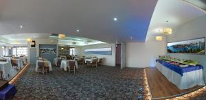 a dining room with tables and chairs in a restaurant at Grand As Hotel in Istanbul
