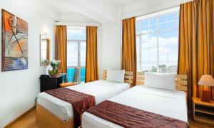Voodi või voodid majutusasutuse Global Towers Hotel & Apartments toas
