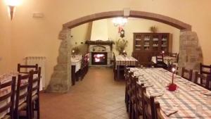 a dining room with long tables and a fireplace at Agriturismo Il Regio Tratturo in Baselice