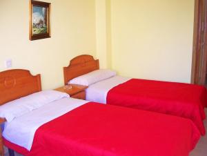 Ένα ή περισσότερα κρεβάτια σε δωμάτιο στο Pension San Marcos