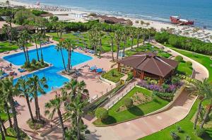 an aerial view of a resort with a swimming pool and the beach at Sahara Beach Aquapark Resort in Monastir