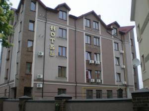 a large brick building with a large window at Palada Hotel in Lviv
