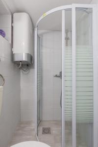 a shower with a glass door in a bathroom at Studio Amore in Dubrovnik