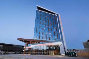 a tall building with a blue facade at Ramada Plaza By Wyndham Konya in Konya